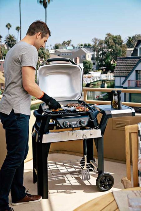 Weber Electric BBQ Pulse 2000 on a Balcony with people cooking